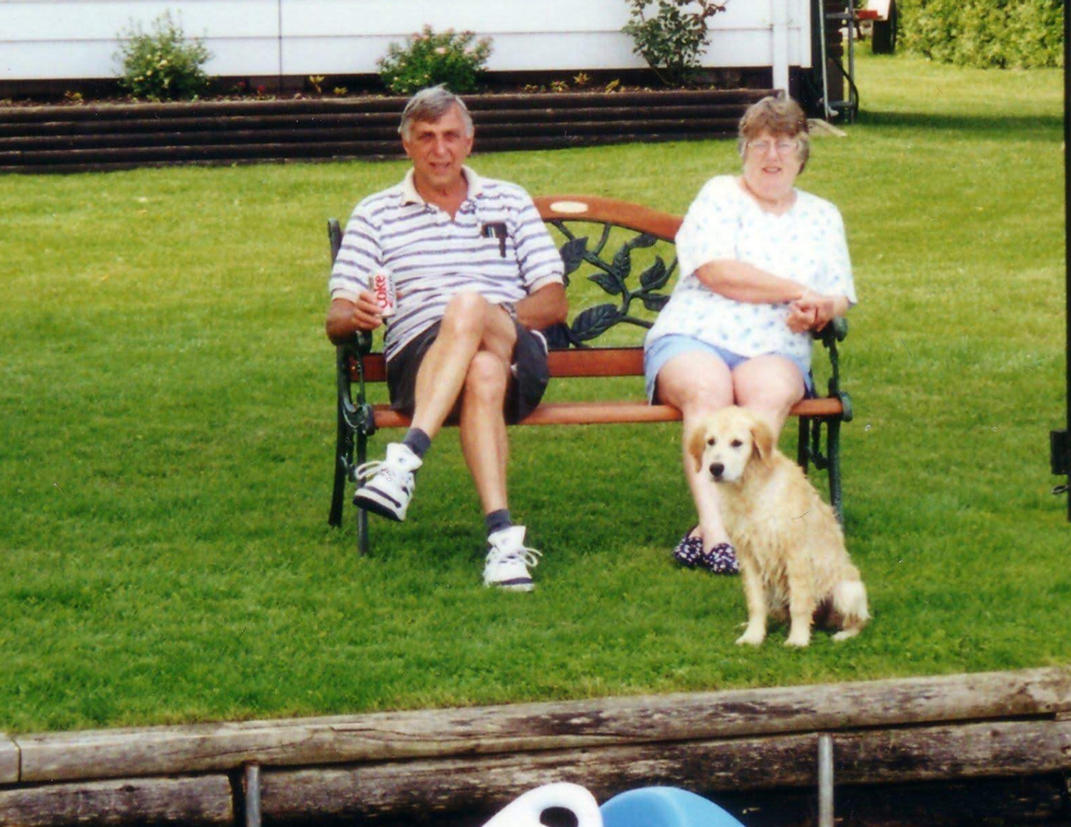 Cliff and Barbara Hooey sitting on a bench by the lake