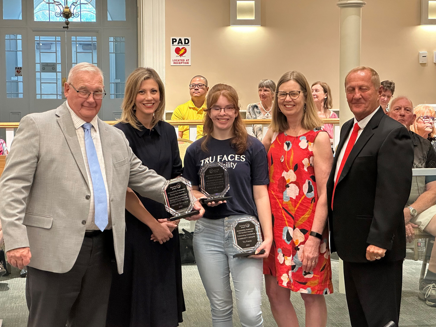 Tru Faces accepting accessibility award