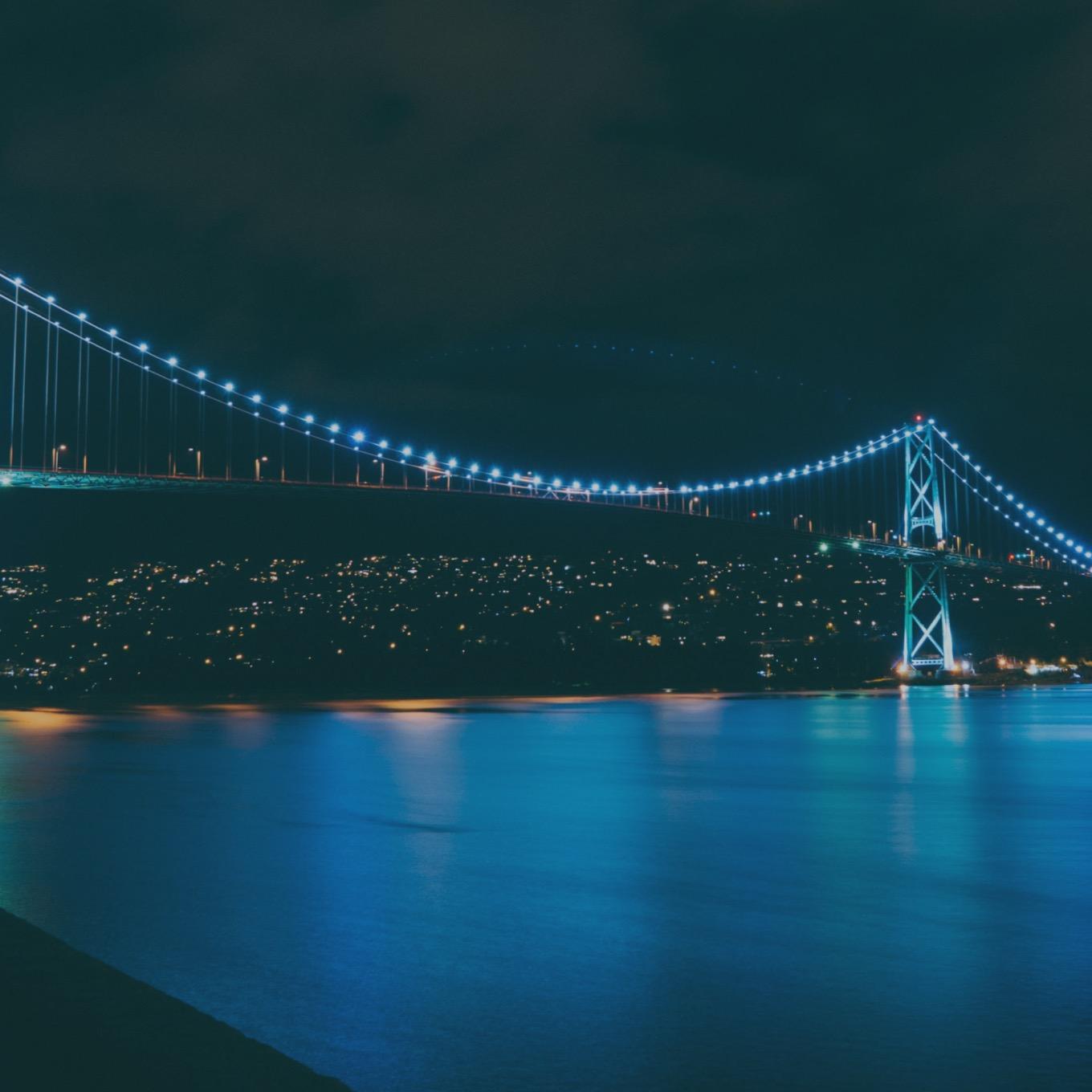 A nighttime photo of the Lions Gate Bridge.
