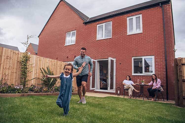 Family playing in a new build home garden
