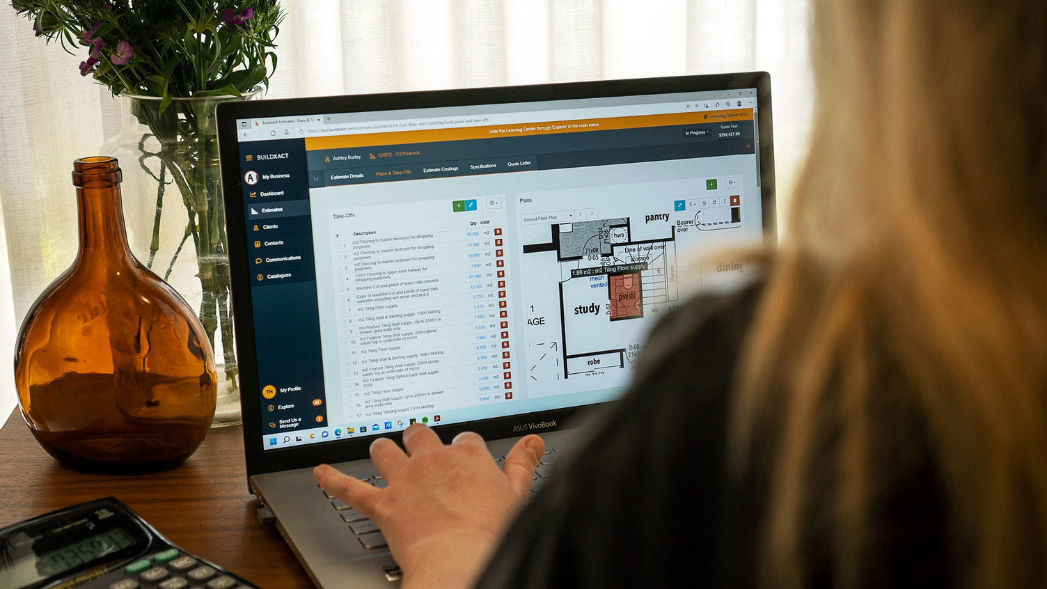 A Buildxact customer performs a takeoff using her laptop