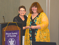 SUNY Empire Assistant Professor Norine Masella, at right, is presented with Tau Kappa At-Large Chapter Recognition for Excellence in Education, at the STTI Honor Society for Nursing induction ceremony.