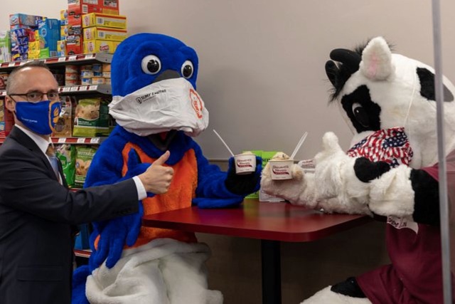 Nathan Gonyea samples Blue Ha-Ha ice cream with mascots Blue and Flavor