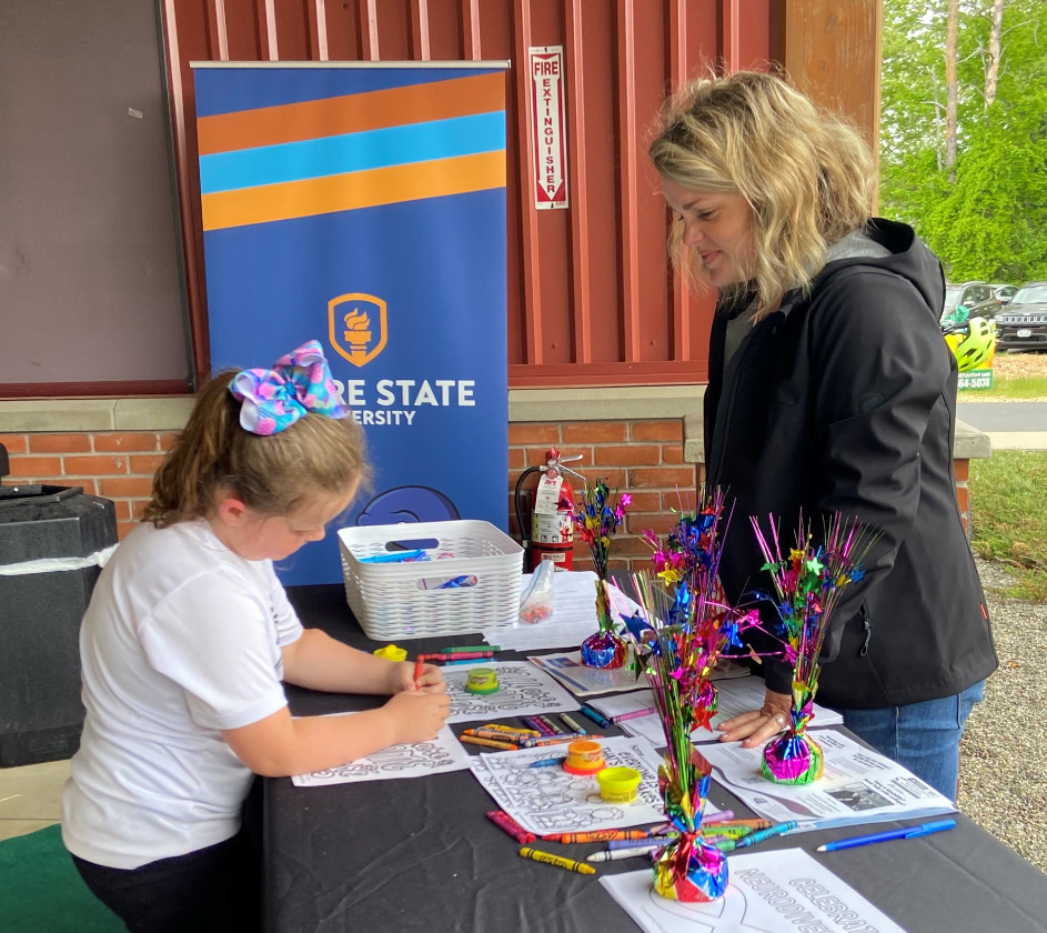 Lauren Allen with child at YMCA event