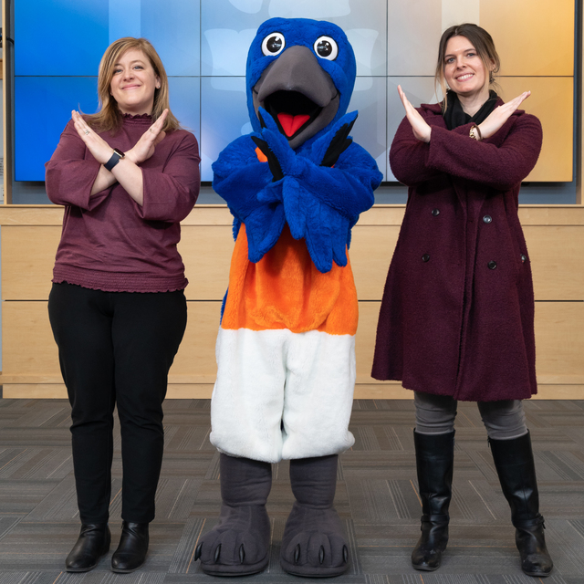 image of mascot and two women