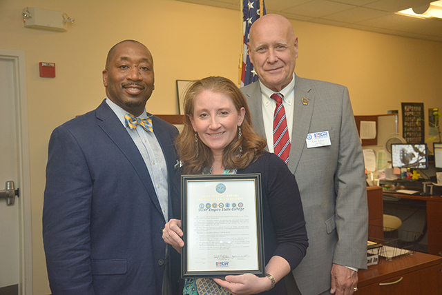 Image of Vice President of Enrollment Management Clayton Steen, left, Desiree Drindak, interim director of the Office of Veteran and Military Education, with Emil Baker, director of military outreach, New York State, who presented her award.
