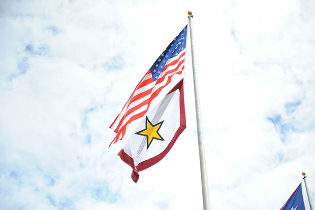 The Flag of the United States of America flies above the Gold Star Mother's and Family's Day flag.