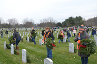 At Wreaths Across America, SUNY Empire alumna Dawn Williams ’06 salutes, and employee Joan DuBois covers her heart, immediately after laying wreaths at the graves of veterans of the U.S. Armed Forces.