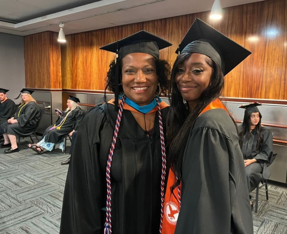 two women in graduation caps