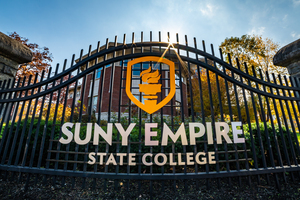 Metal gate with SUNY Empire State College logo