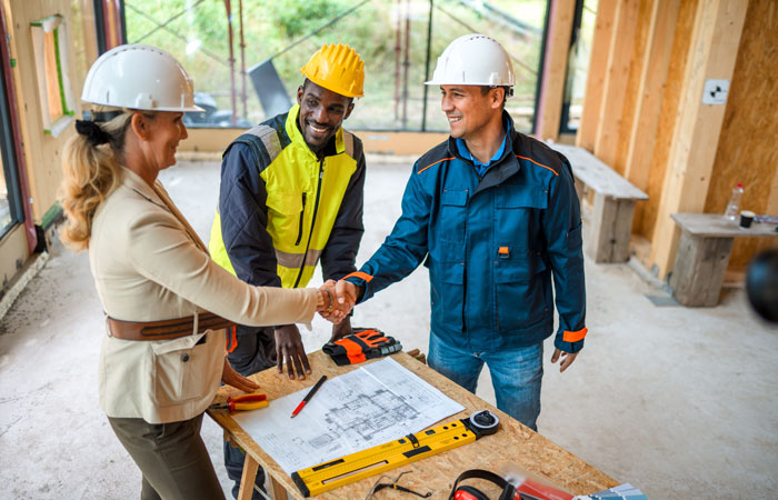 People in a worksite shaking hands