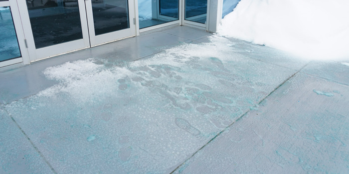 Ice melt on the sidewalk in front of a building entryway