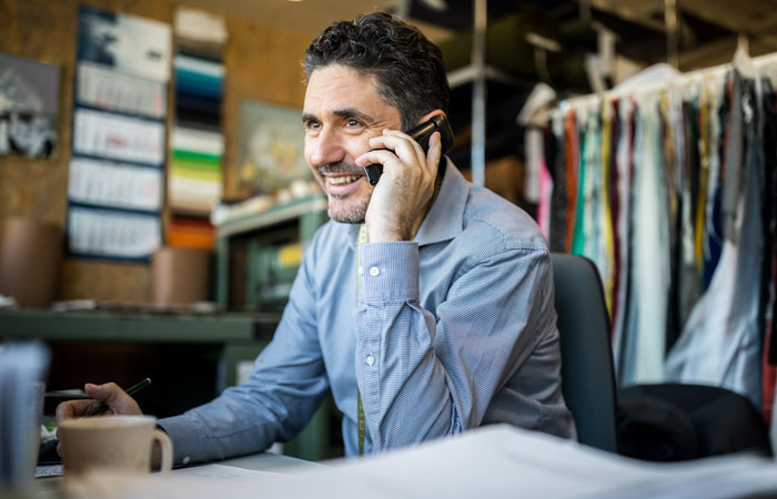 A person on the phone in a dry cleaner business