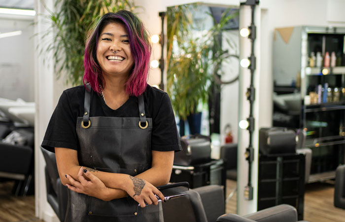 A hair stylist in a their salon