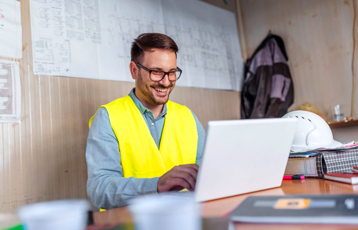 A man at a desk working on a laptop