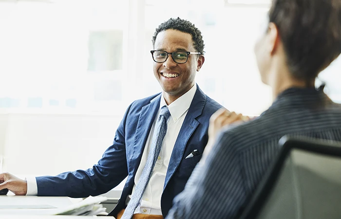 A man smiling in a meeting