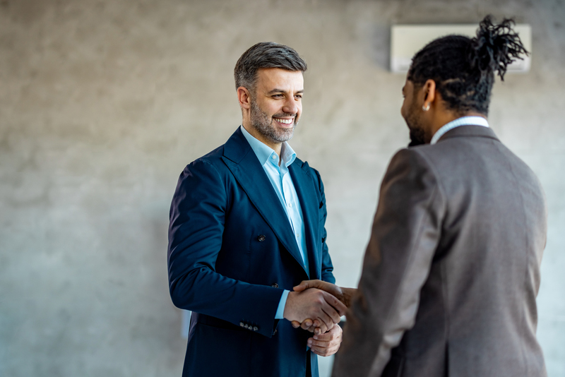 Two people in suits shaking hands