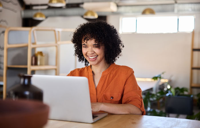 A woman at a laptop working