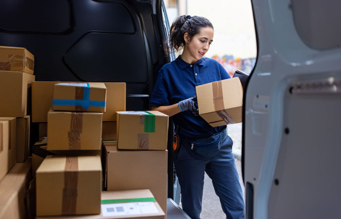 A delivery driver holding a package