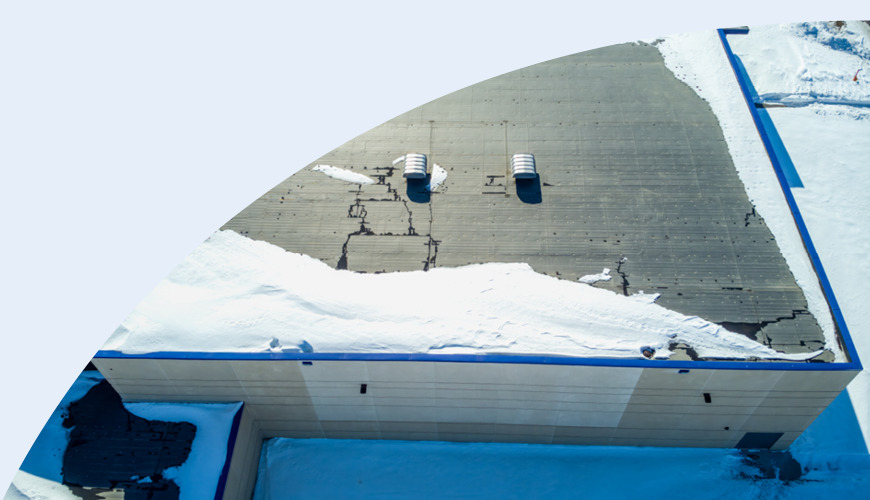 Building rooftop covered in snow