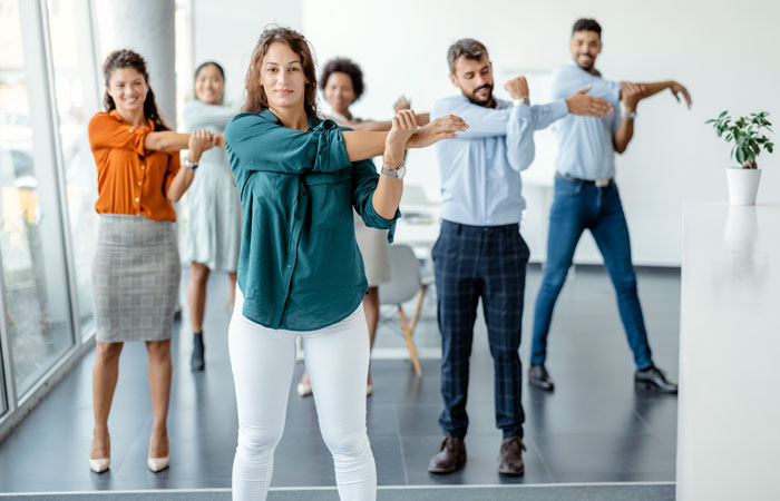 Group of employees participating in a stretching session