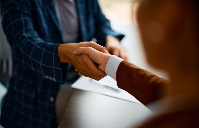 A close up of two people shaking hands