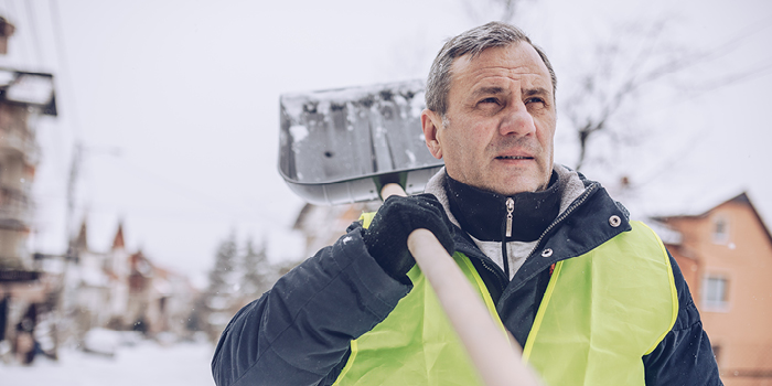 man holding snow shovel