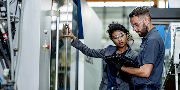 two people looking at machine