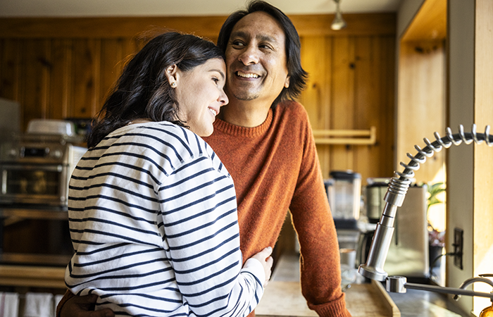 A couple in a home embracing each other