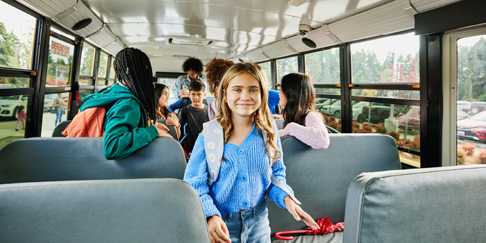 young girl getting on bus