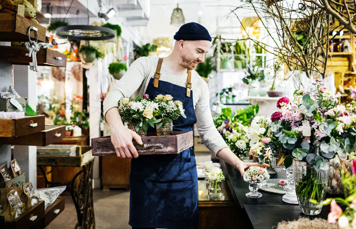 a person working in a small business flower shop