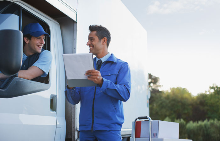 A driver talking to an employee handling a shipping order