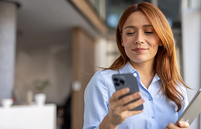 A woman looking at her phone working