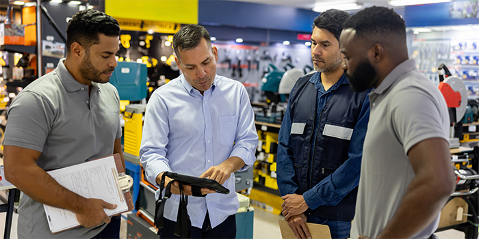People in a retail store looking at a tablet