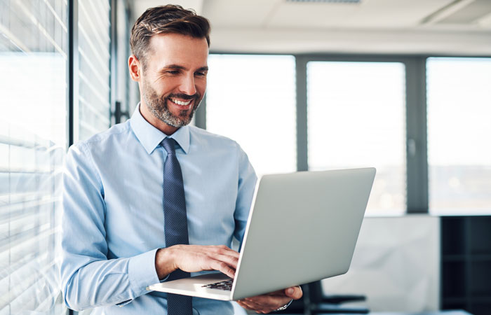 A man working on a laptop in an office