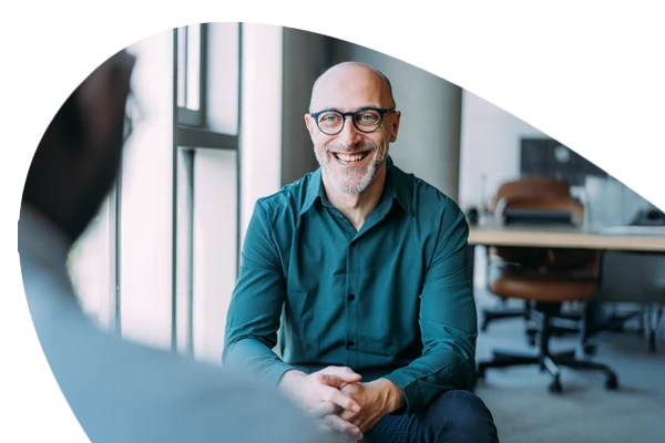 A man talking to a person in the office