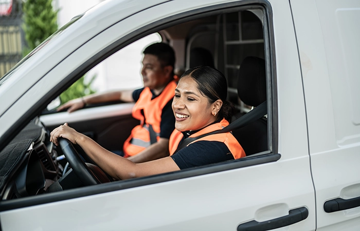 Two people driving in a fleet vehicle