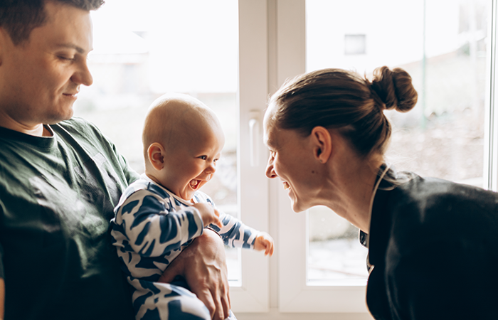 A couple playing with their baby