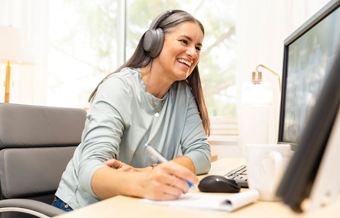 A woman working at a desk on a video call