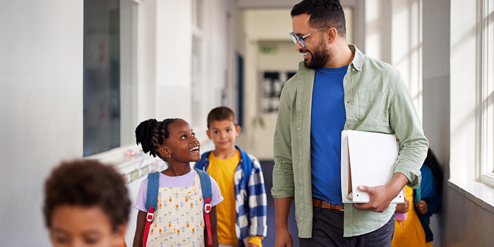 teacher walking down hallway with students