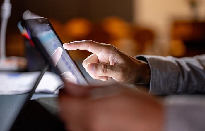 A close up of someone tapping on a tablet