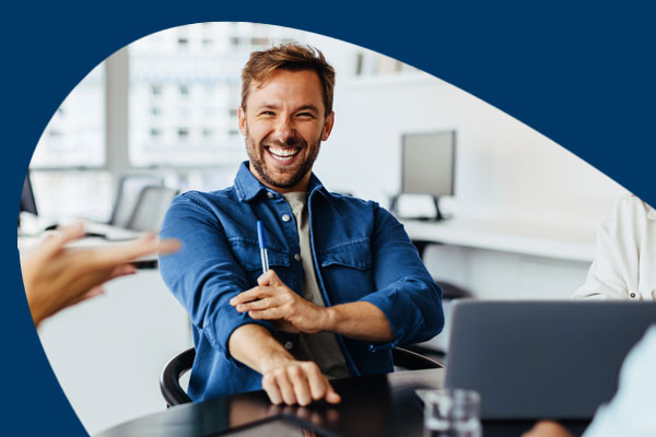 Man smiling in a meeting