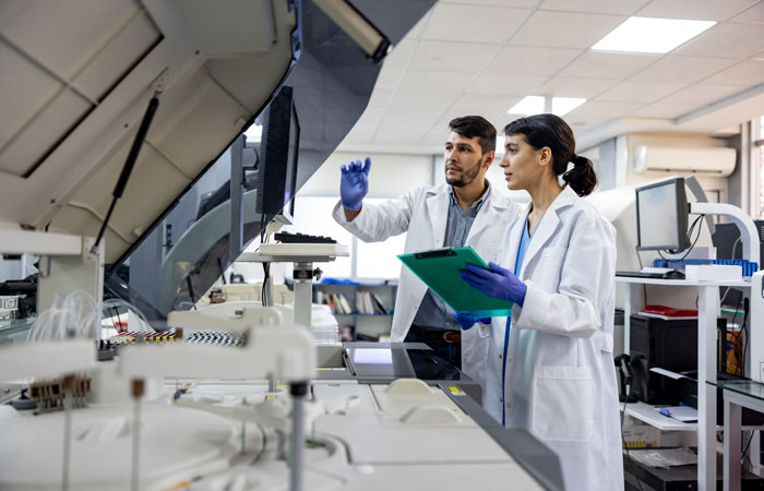 Two people in a lab setting looking at a screen