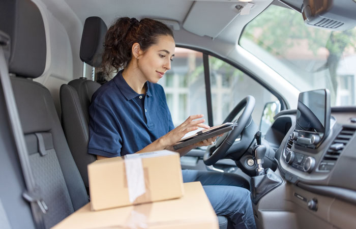 A woman working in her company vehicle