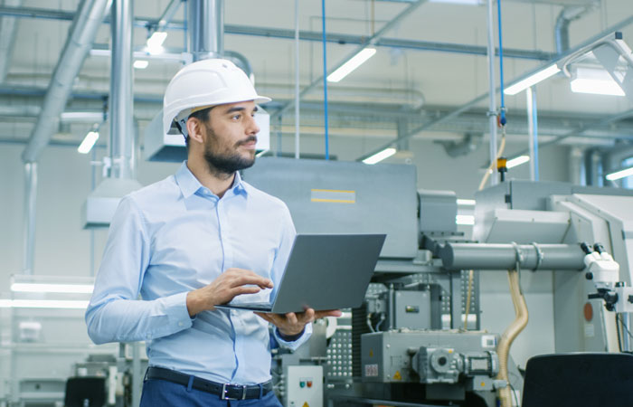 A worker in a hardhat in a factory