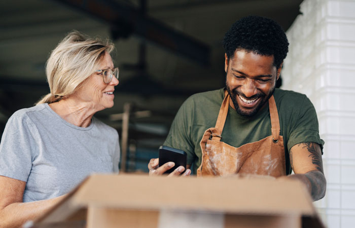 Two workers opening boxes
