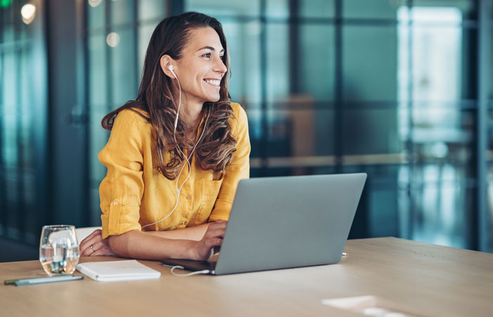 A woman smiling, working in an office