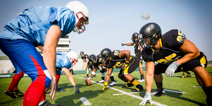 football players lining up to tackle