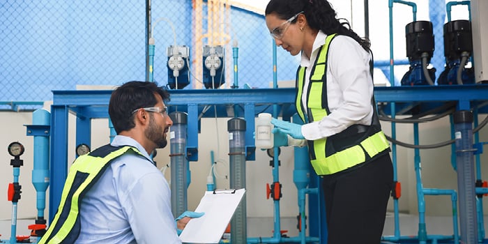 Two workers in hi-viz safety vest.