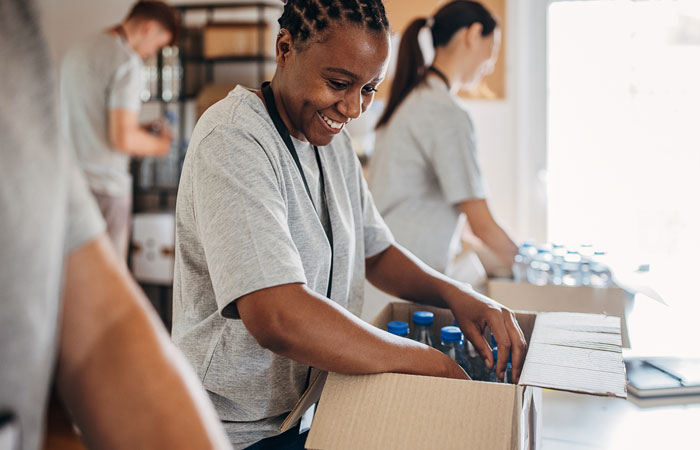 Woman packing a box of supplies